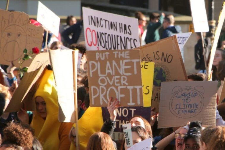 placard says "planet over profit"