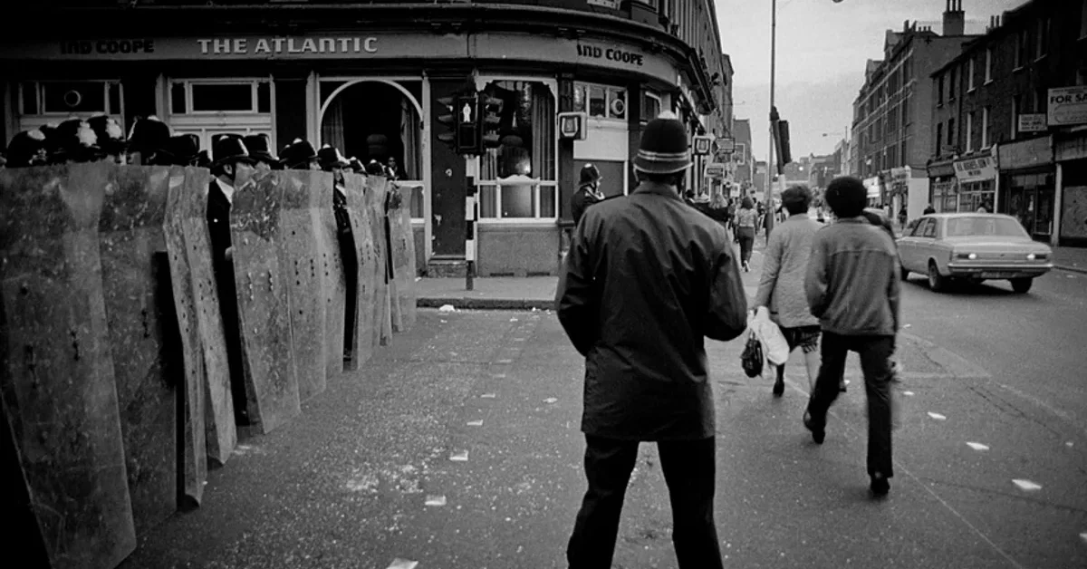 Police with riot shields outside the Atlantic pub in Brixton during the April 1981 uprising