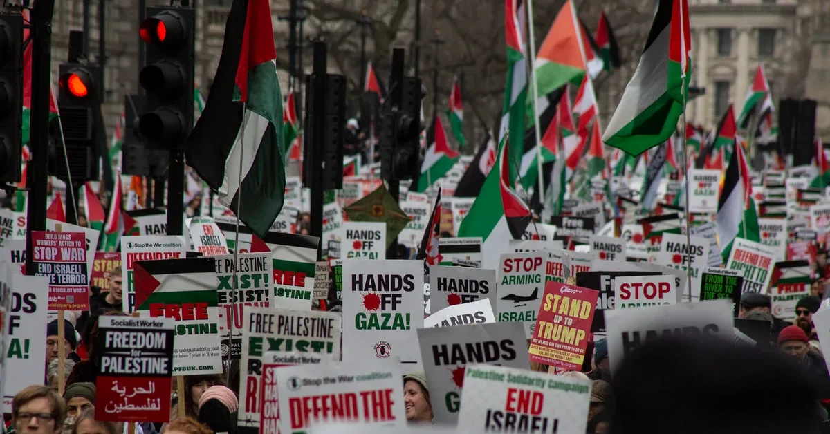 Crowd holding Palestinian flags and placards at a London solidarity demonstration in February 2025 (archive photograph)